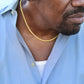 man wearing yellow gold cuban link chain