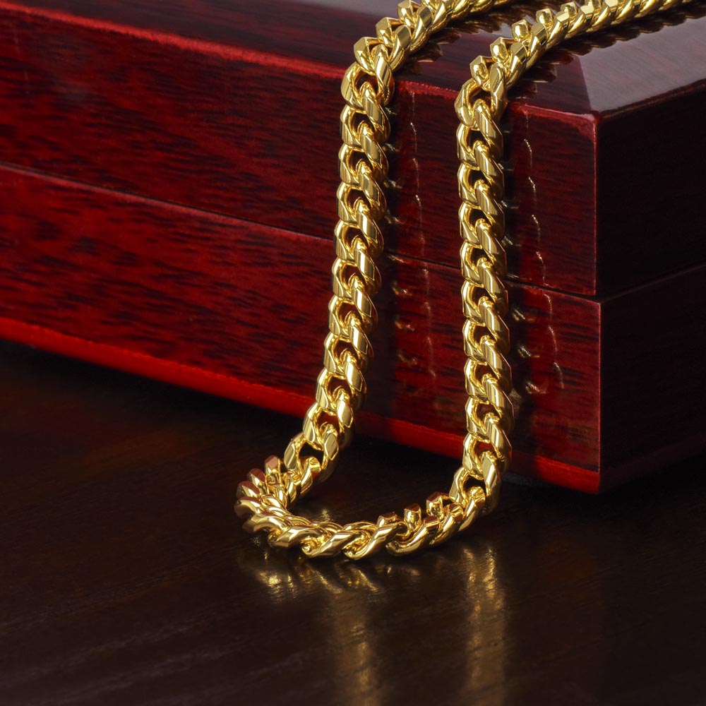 yellow gold cuban link chain on display